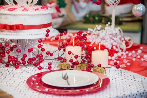 Romantic holiday Christmas table setting with burning candles.